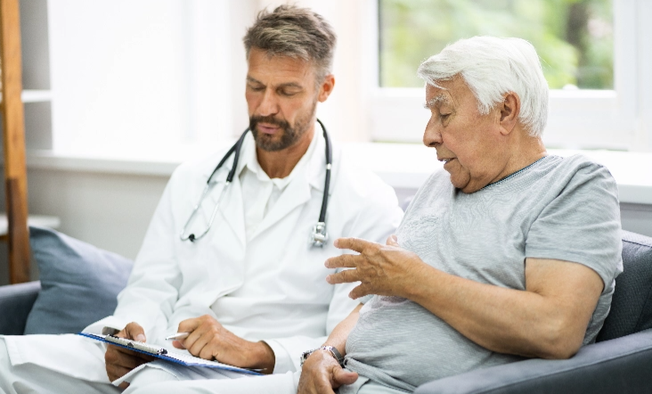 A doctor and patient mid discussion, the doctor is taking notes